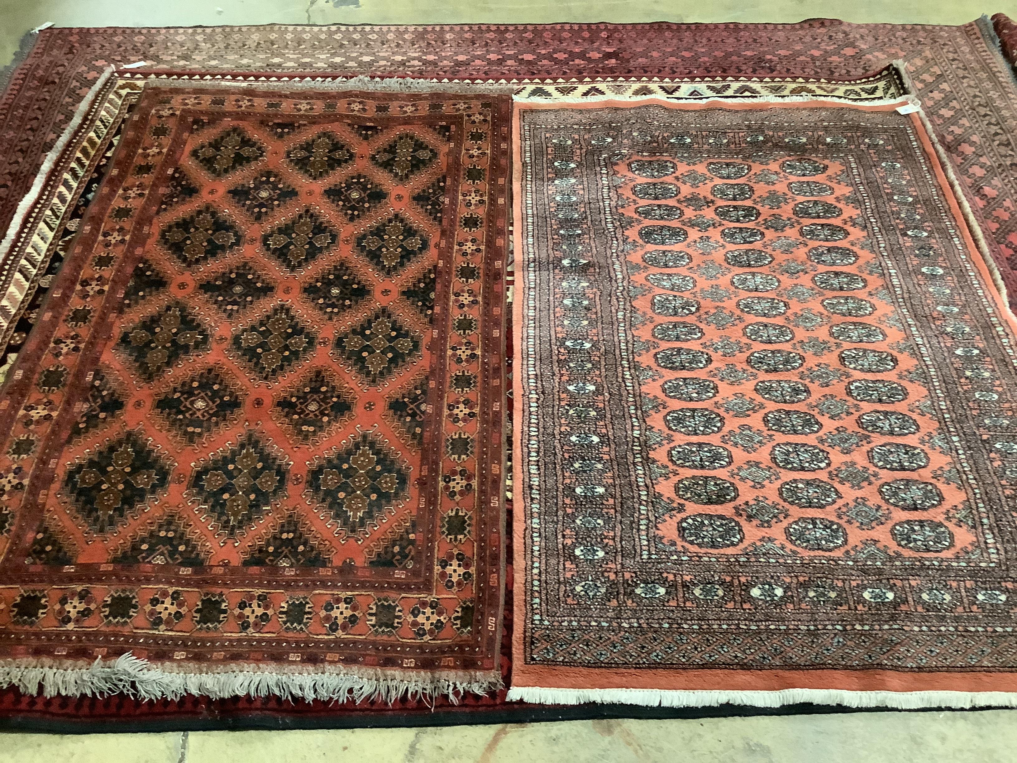 A Caucasian brick red ground rug, 196 x 120cm and a cotton pile Bokhara rug, 193 x 128cm